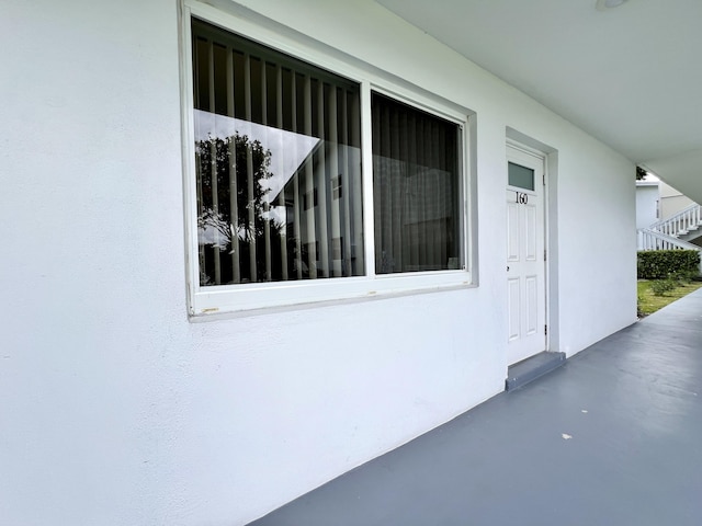 view of exterior entry featuring stucco siding