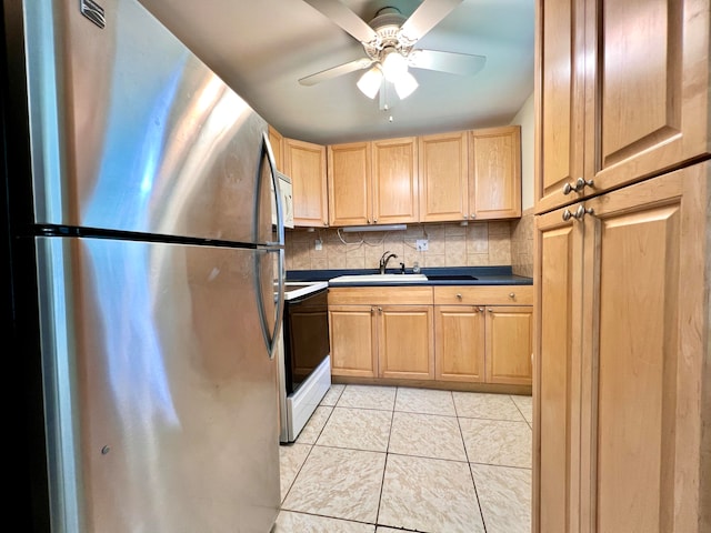 kitchen featuring ceiling fan, decorative backsplash, sink, white range with electric cooktop, and stainless steel fridge