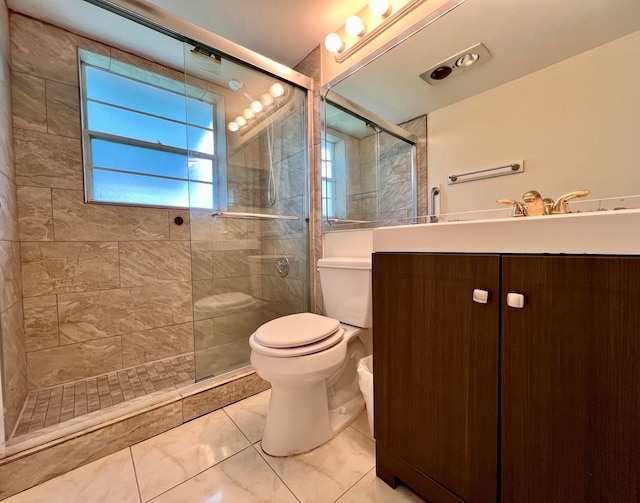 bathroom featuring toilet, an enclosed shower, tile patterned flooring, and vanity