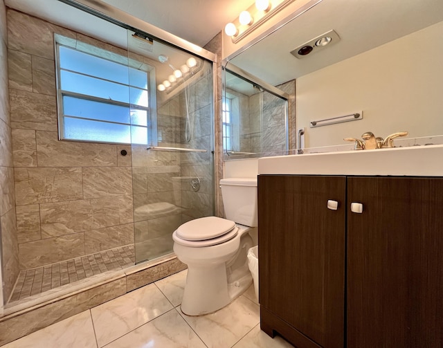 bathroom featuring toilet, a tile shower, marble finish floor, and vanity