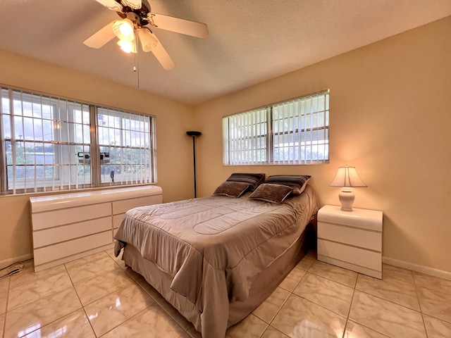 bedroom featuring a ceiling fan and baseboards
