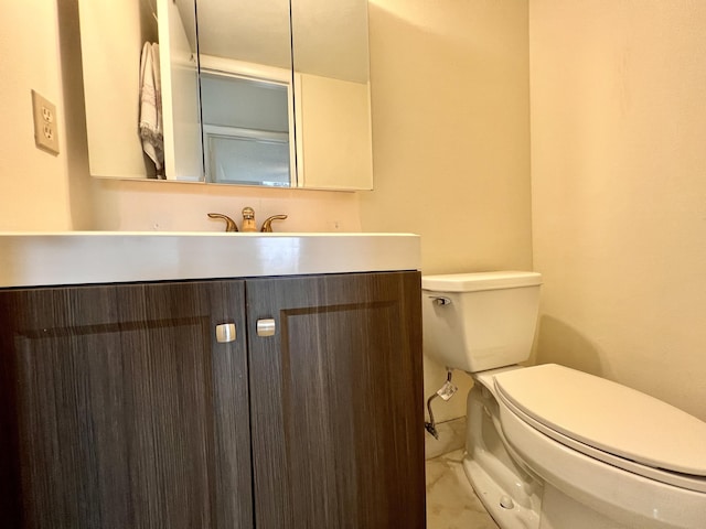 bathroom featuring vanity, marble finish floor, and toilet