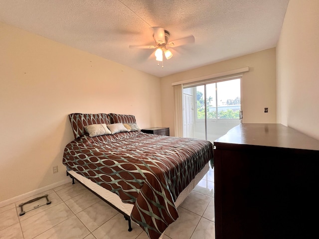 bedroom featuring ceiling fan, access to outside, light tile patterned flooring, and a textured ceiling