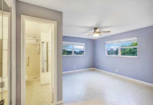 empty room featuring ceiling fan and light tile patterned flooring