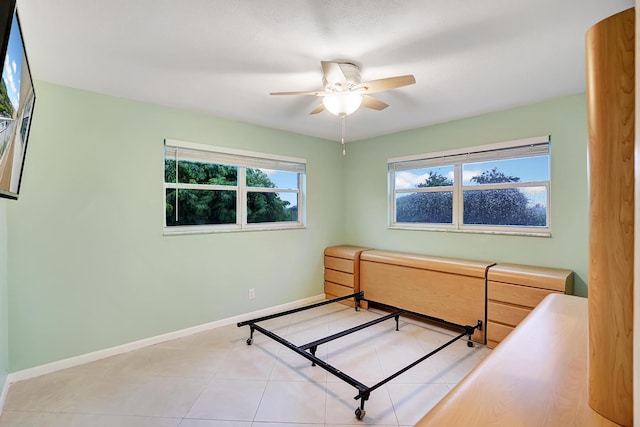 tiled bedroom featuring ceiling fan