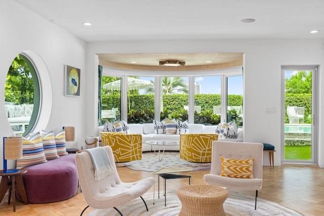 living area featuring a healthy amount of sunlight and light parquet flooring