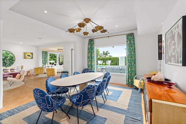 dining space with a healthy amount of sunlight, a chandelier, and light parquet floors