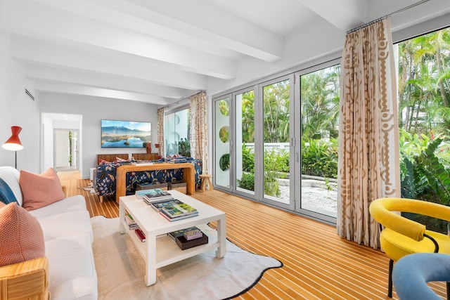 living room with hardwood / wood-style floors and beam ceiling