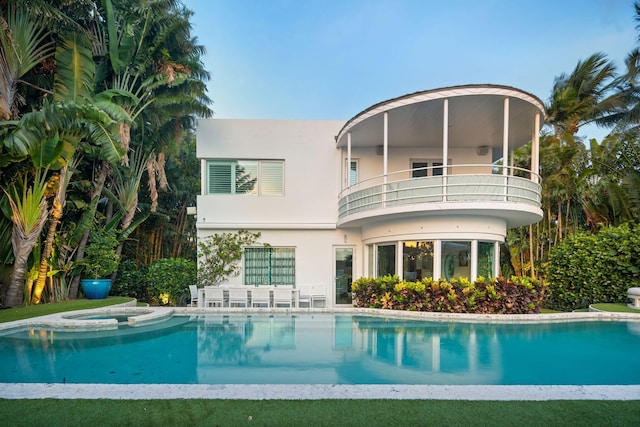 rear view of property featuring a balcony