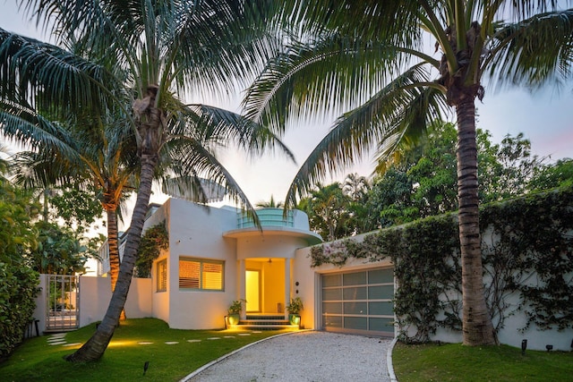 view of front of house featuring a garage and a lawn