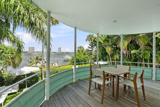 sunroom featuring a water view