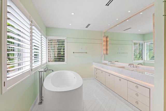 bathroom with vanity, a bathtub, and parquet flooring