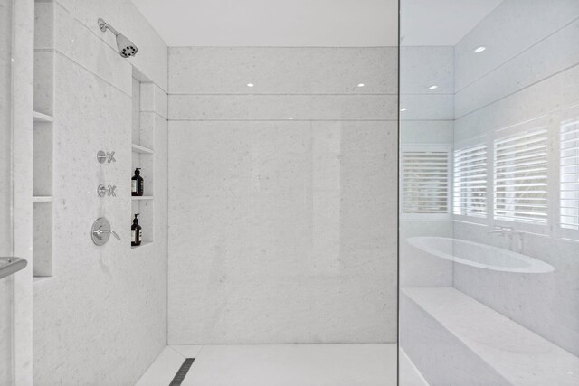 bathroom featuring a shower with shower door, vanity, and tile floors