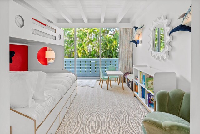 carpeted bedroom featuring beam ceiling