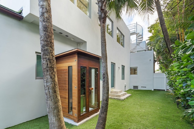 rear view of house featuring a yard, french doors, and a balcony