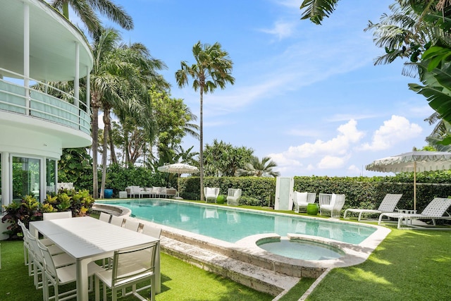 view of pool featuring an in ground hot tub, a patio, and a lawn