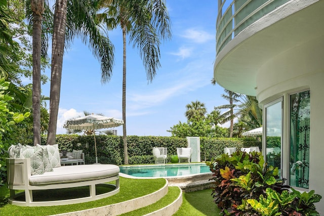 view of pool featuring a lawn