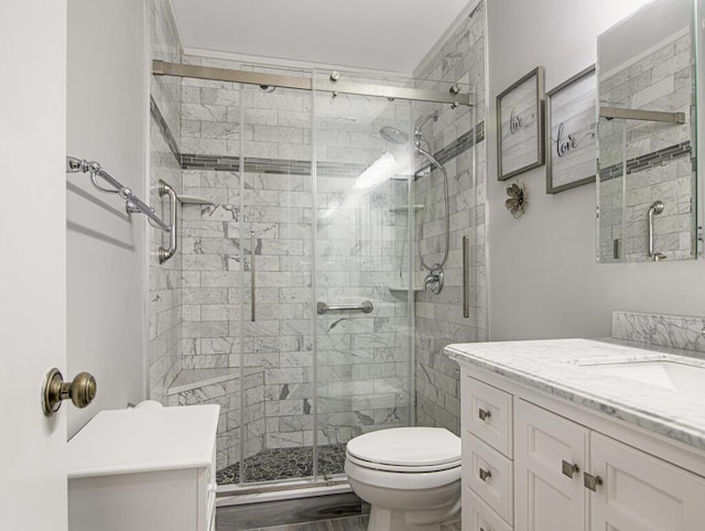 bathroom featuring vanity, toilet, and walk in shower