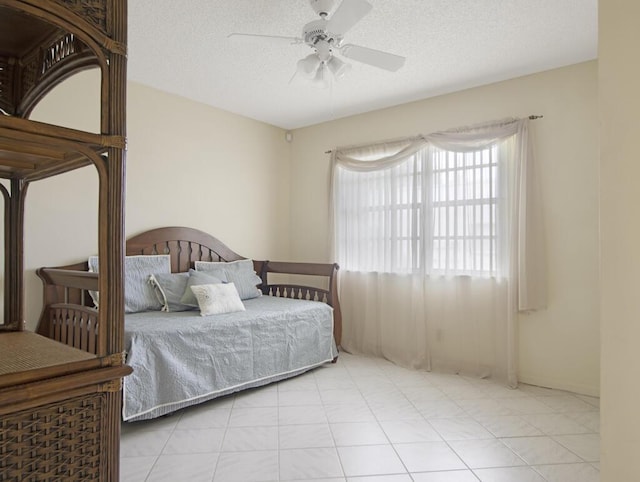 bedroom featuring ceiling fan and a textured ceiling