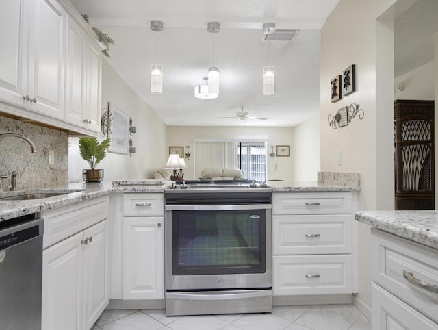 kitchen with sink, ceiling fan, tasteful backsplash, white cabinetry, and stainless steel appliances