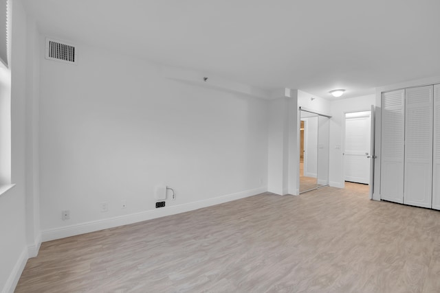 unfurnished room featuring light wood-type flooring