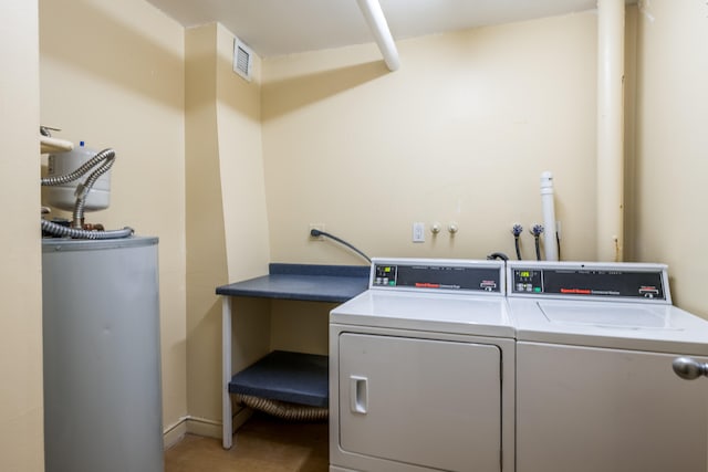 laundry room with washer and dryer, water heater, and hookup for a washing machine