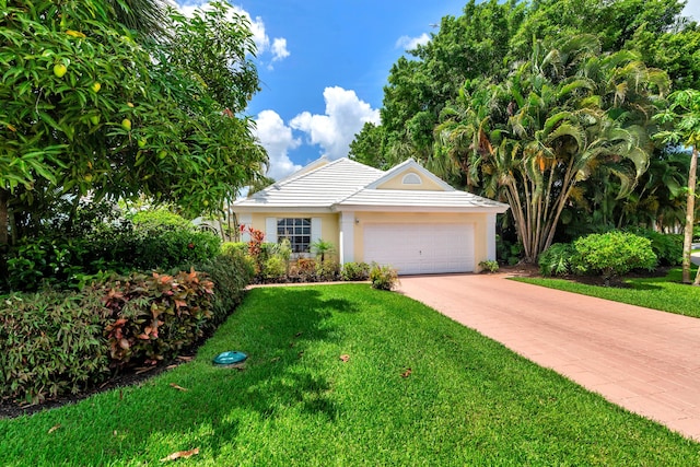 view of front of property featuring a garage and a front yard