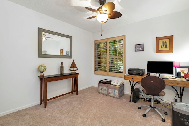 carpeted home office featuring ceiling fan and a textured ceiling