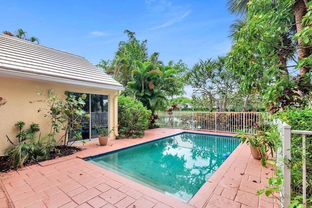 view of pool featuring a patio area and a water view