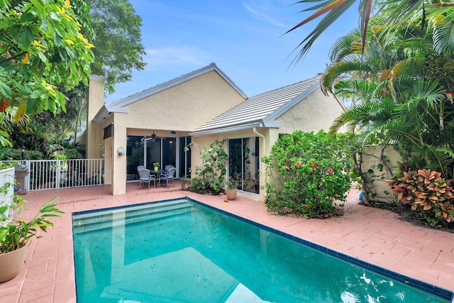 view of pool with a patio and ceiling fan