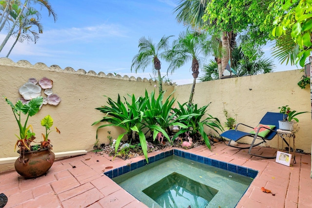 view of pool featuring an in ground hot tub and a patio