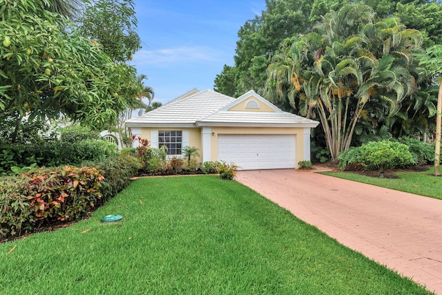 single story home featuring a front yard and a garage