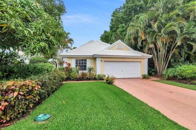 view of front facade with a garage and a front lawn