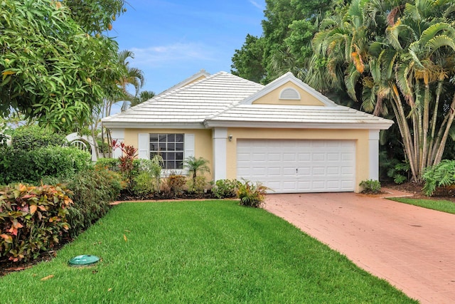 view of front of property featuring a front yard and a garage