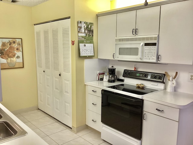 kitchen with white appliances and light tile patterned floors