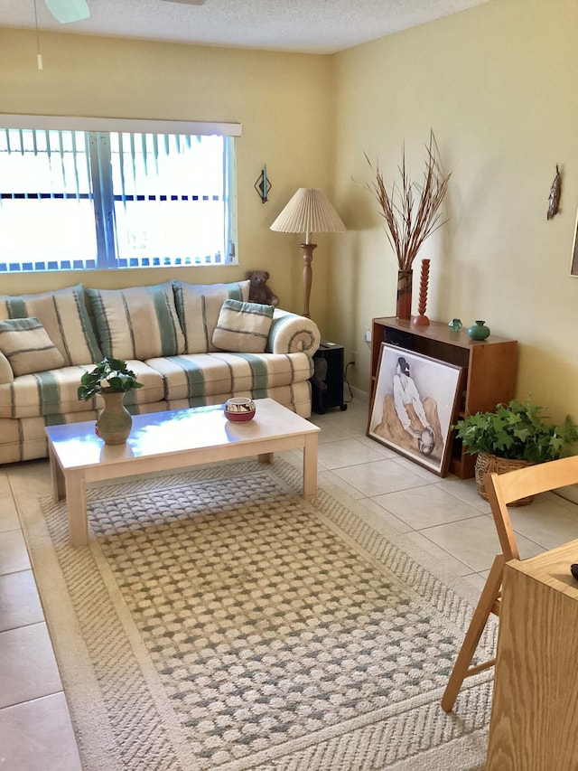 living room featuring a textured ceiling and light tile patterned flooring