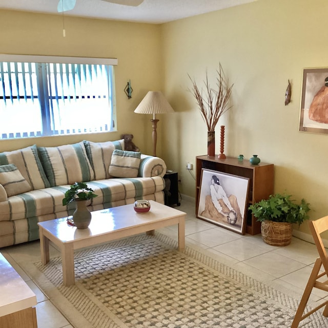 living room with ceiling fan and light tile patterned flooring