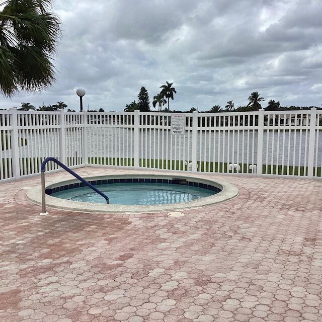 view of pool with an in ground hot tub