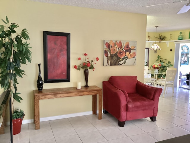 living area with light tile patterned floors and a textured ceiling