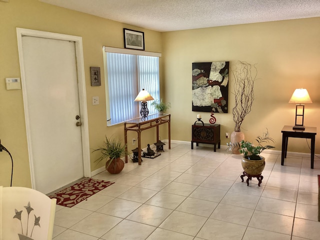 tiled foyer entrance with a textured ceiling