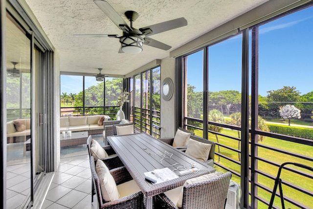 sunroom featuring a wealth of natural light and ceiling fan