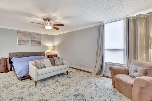 bedroom featuring crown molding, a textured ceiling, and ceiling fan