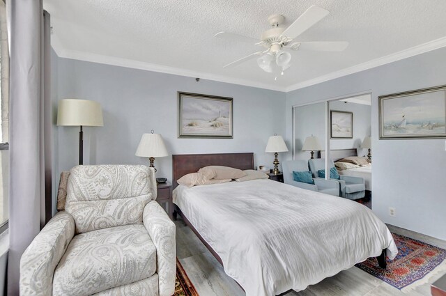 bedroom with a textured ceiling, ceiling fan, and ornamental molding