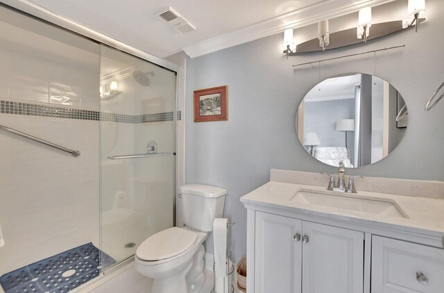 bathroom with an enclosed shower, tile patterned floors, toilet, vanity, and ornamental molding