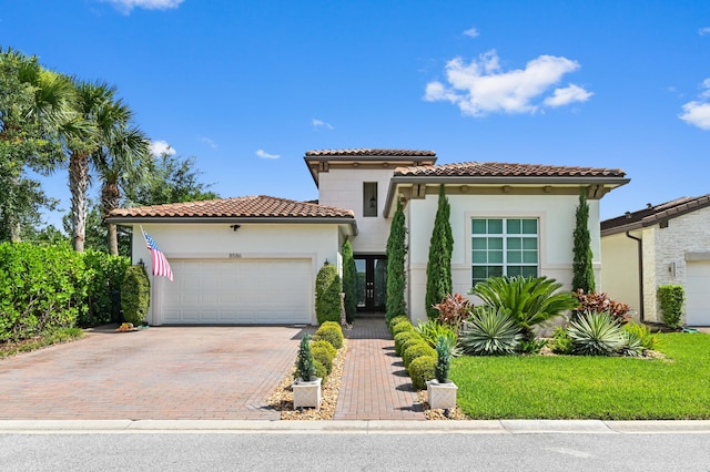 mediterranean / spanish home with a garage