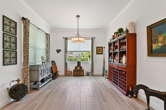 living area with ornamental molding and light wood-type flooring