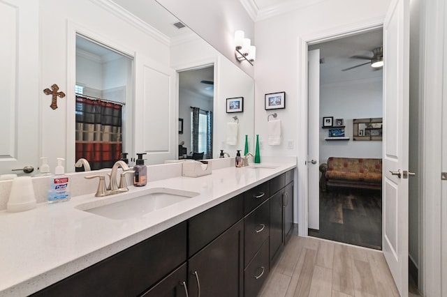 bathroom featuring ceiling fan, ornamental molding, and vanity