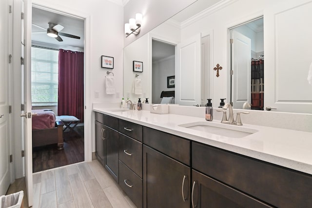 bathroom featuring vanity, crown molding, and ceiling fan