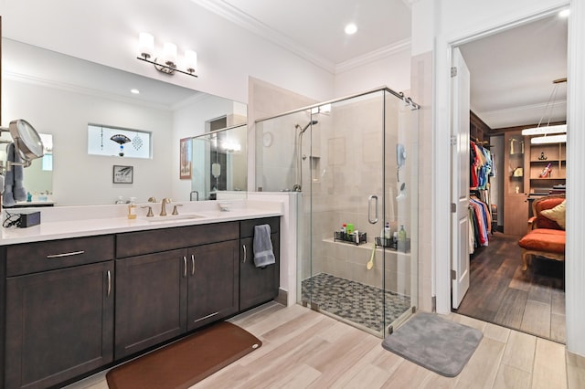 bathroom with vanity, ornamental molding, and walk in shower