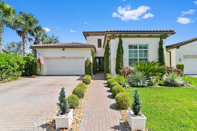 mediterranean / spanish home featuring a garage